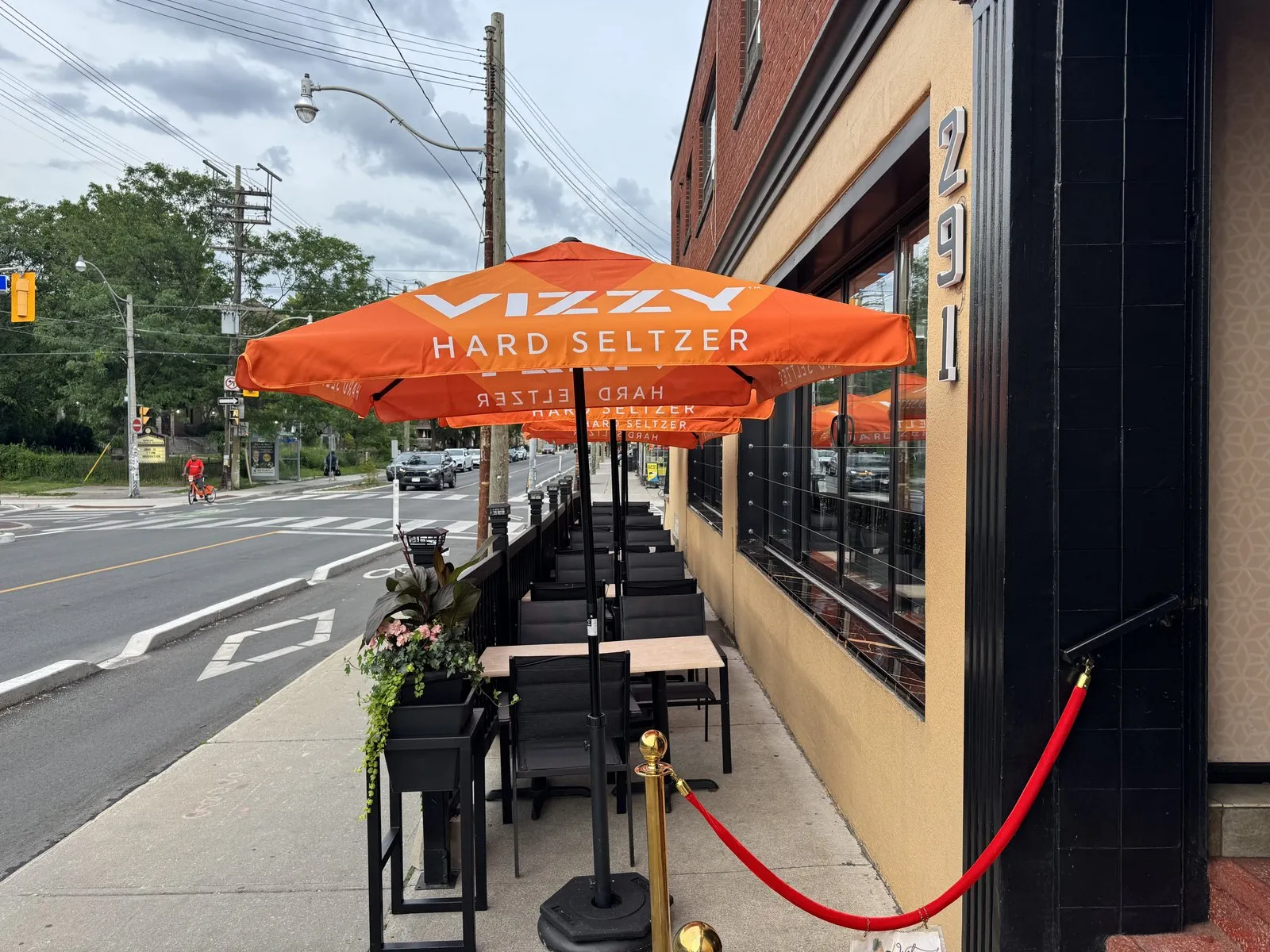 A corner view of the patio umbrellas with the street and crosswalk beyond