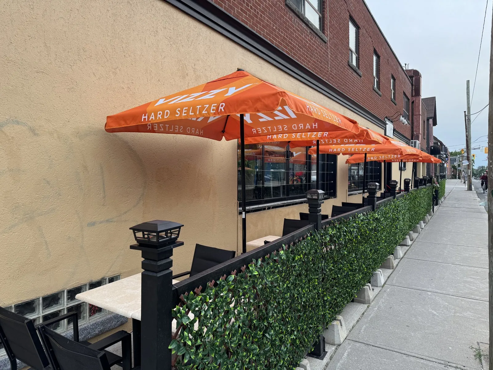 Side view of the patio umbrellas and tables tucked against the building