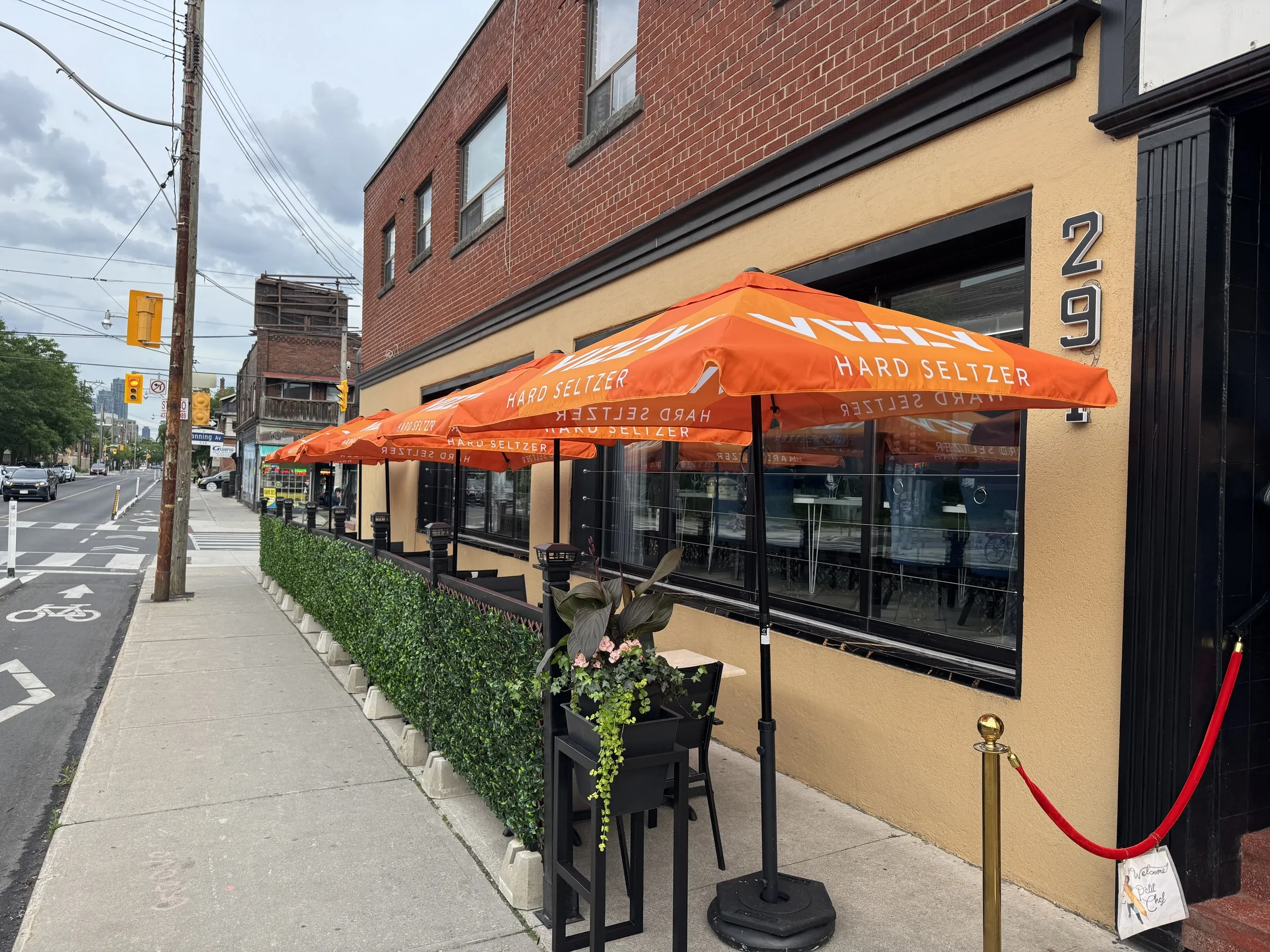 Ace Restaurant patio with bistro tables, greenery and string lights